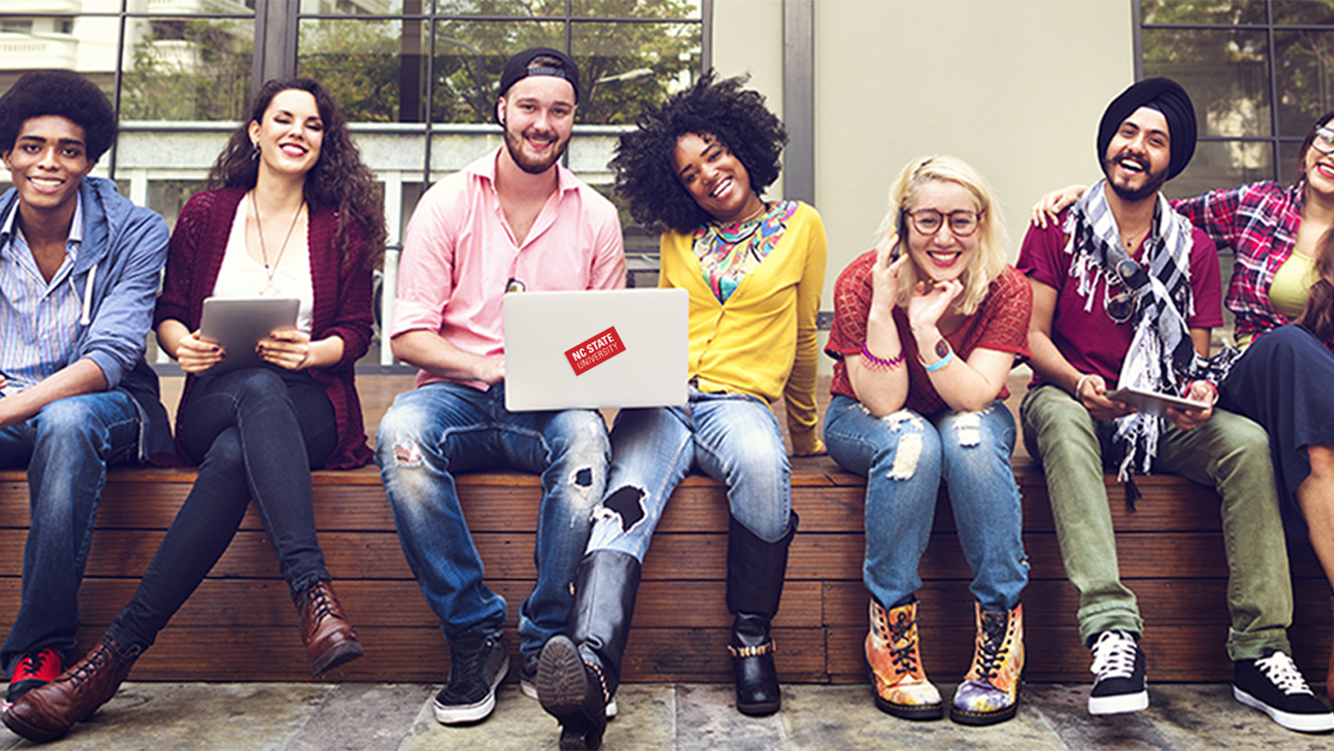 Group of diverse students sitting together and smiling