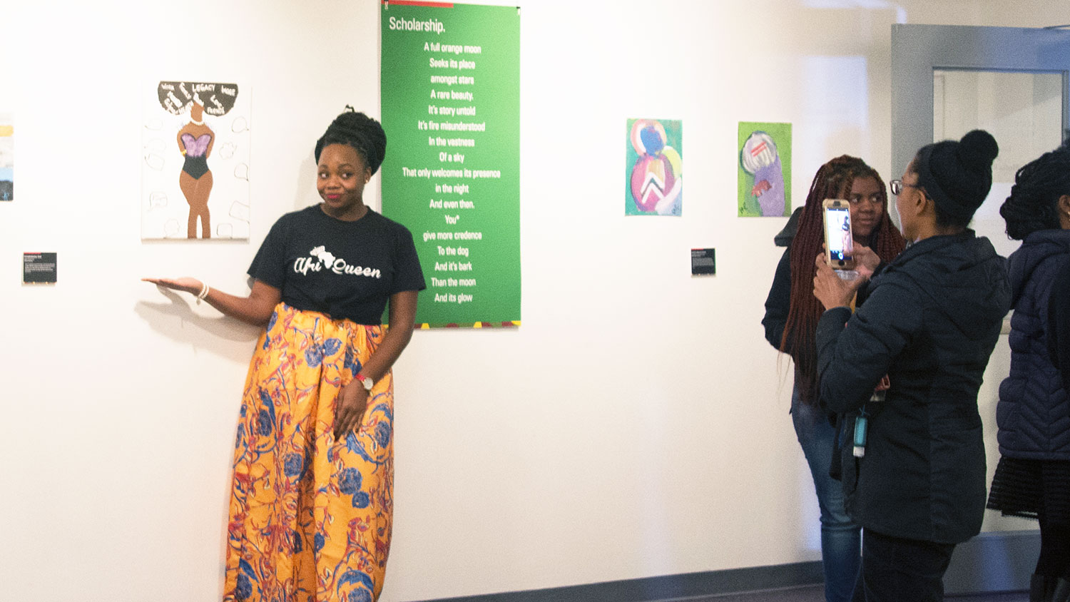 Black Bodies Exhibit artist poses with artwork