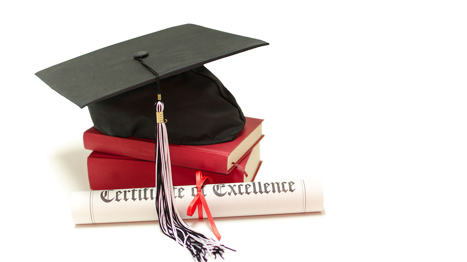 Mortarboard, books and certificate of excellence