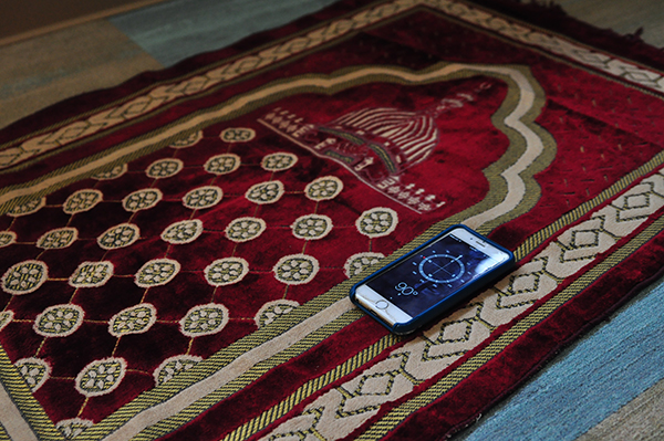 Prayer rug and compass in prayer space