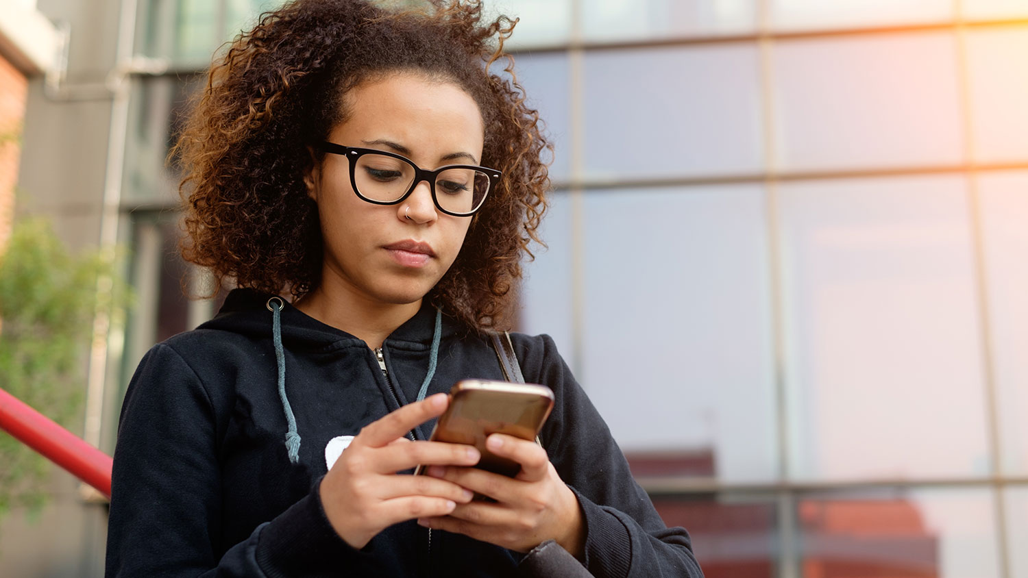 Student filing a report on her phone