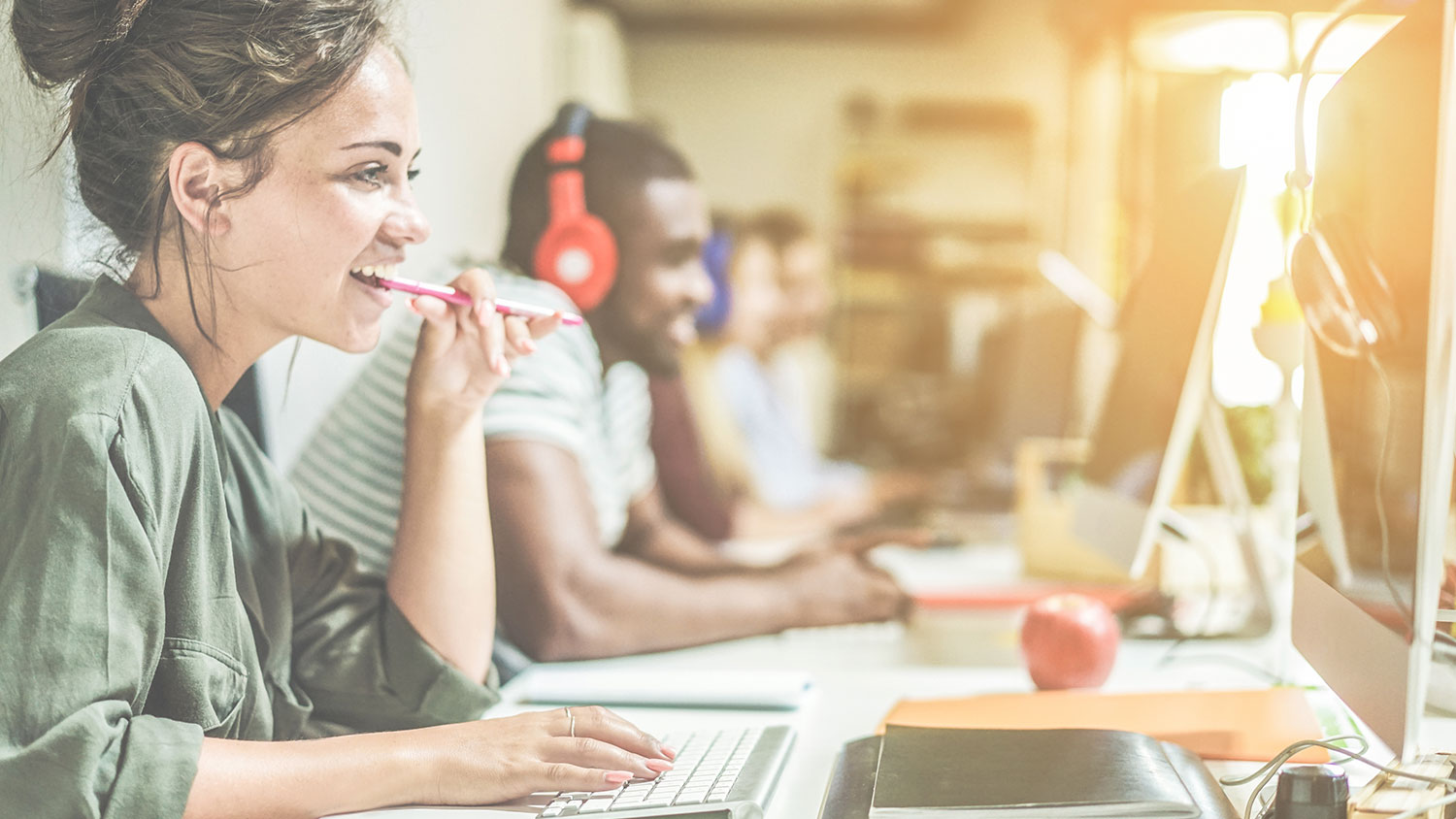 Smiling student in computer lab lookiing at website