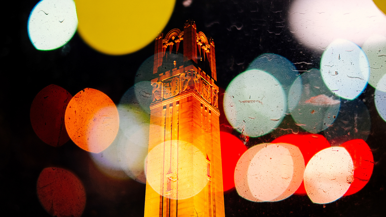 NC State Belltower at night with refractions of light