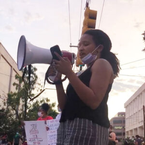 Melanie Flowers, student body president, at a protest with megaphone