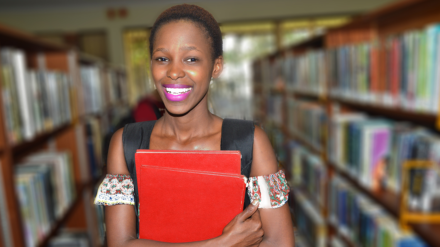 Woman holding books in a library