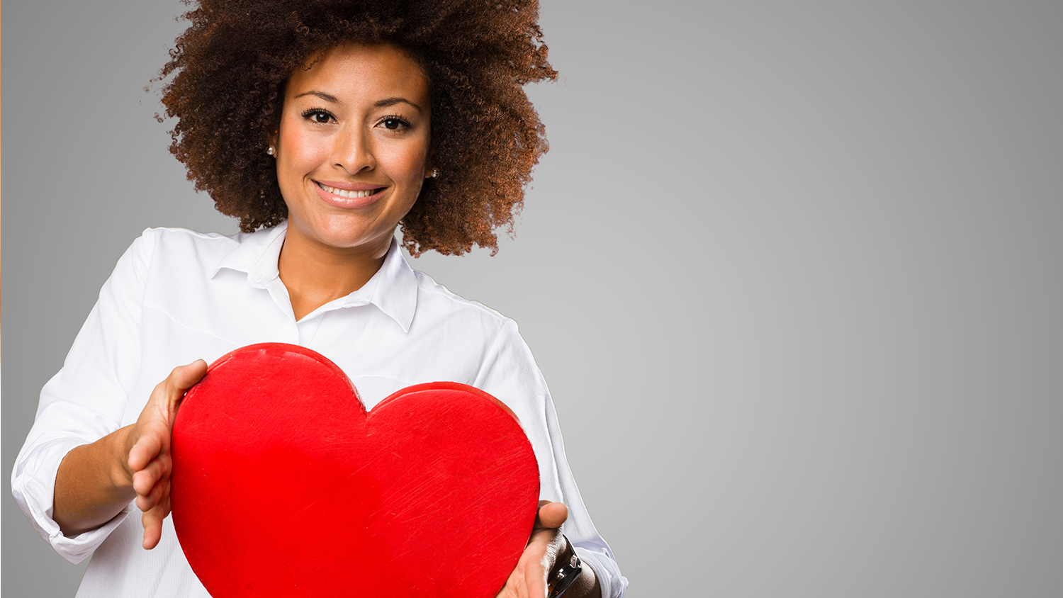 Woman holding large red heart