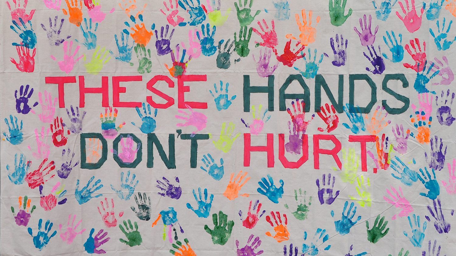 Banner that says These Hands Don't Hurt