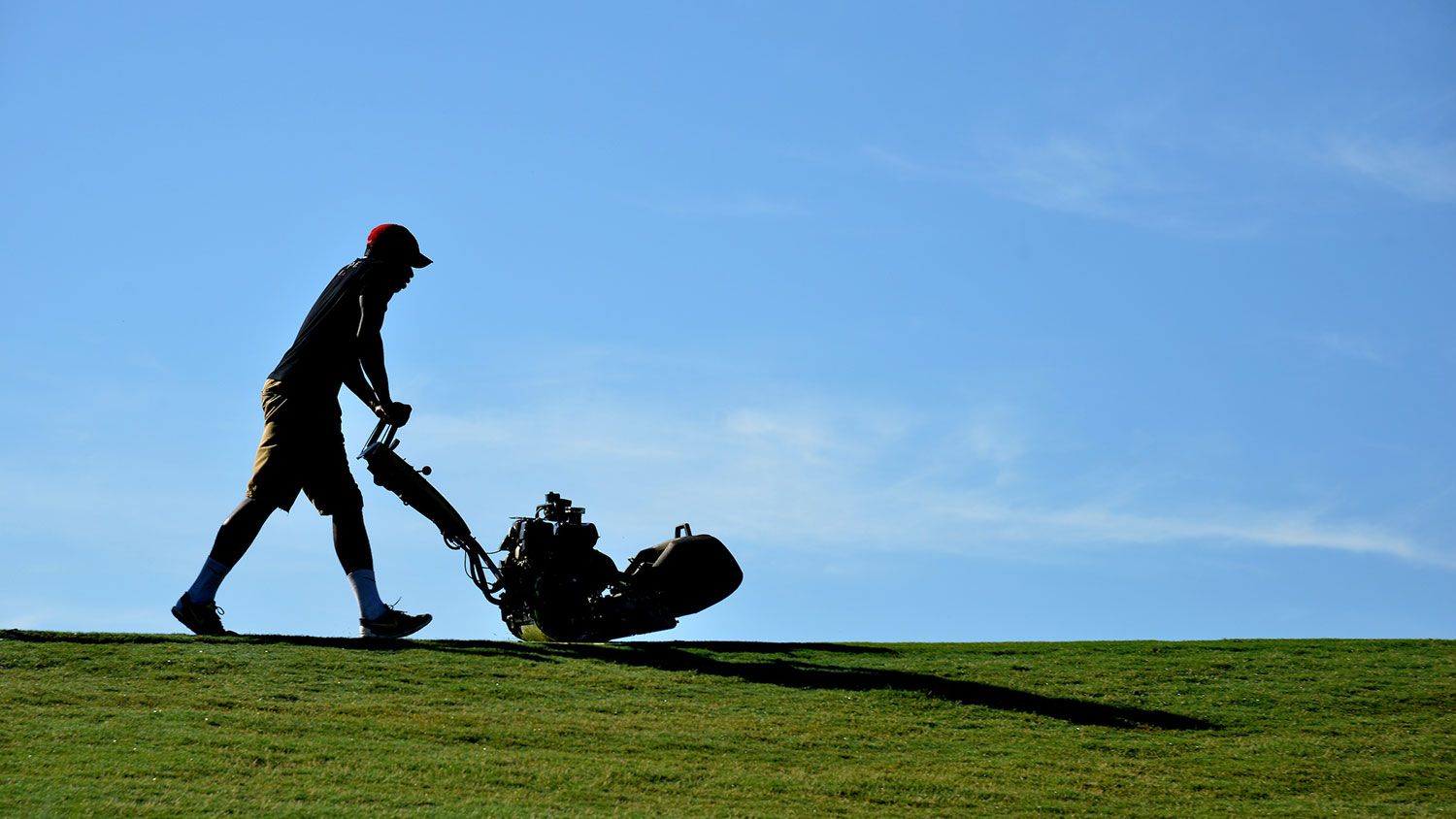 A man mows the golf course