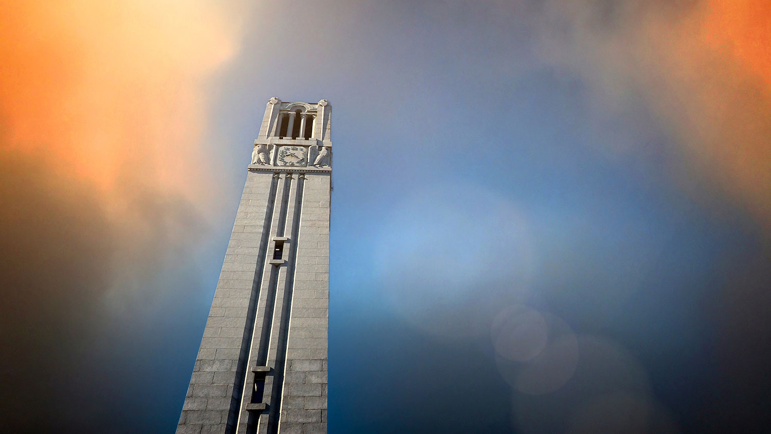 NC State Belltower with orange sky