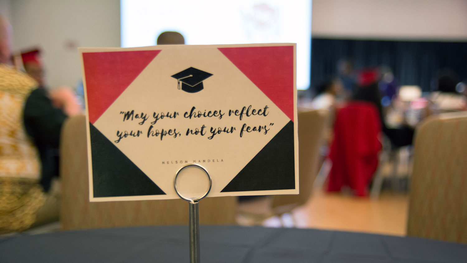 Table with placard showing Nelson Mandela quote, "May your choices reflect your hopes, not your fears"