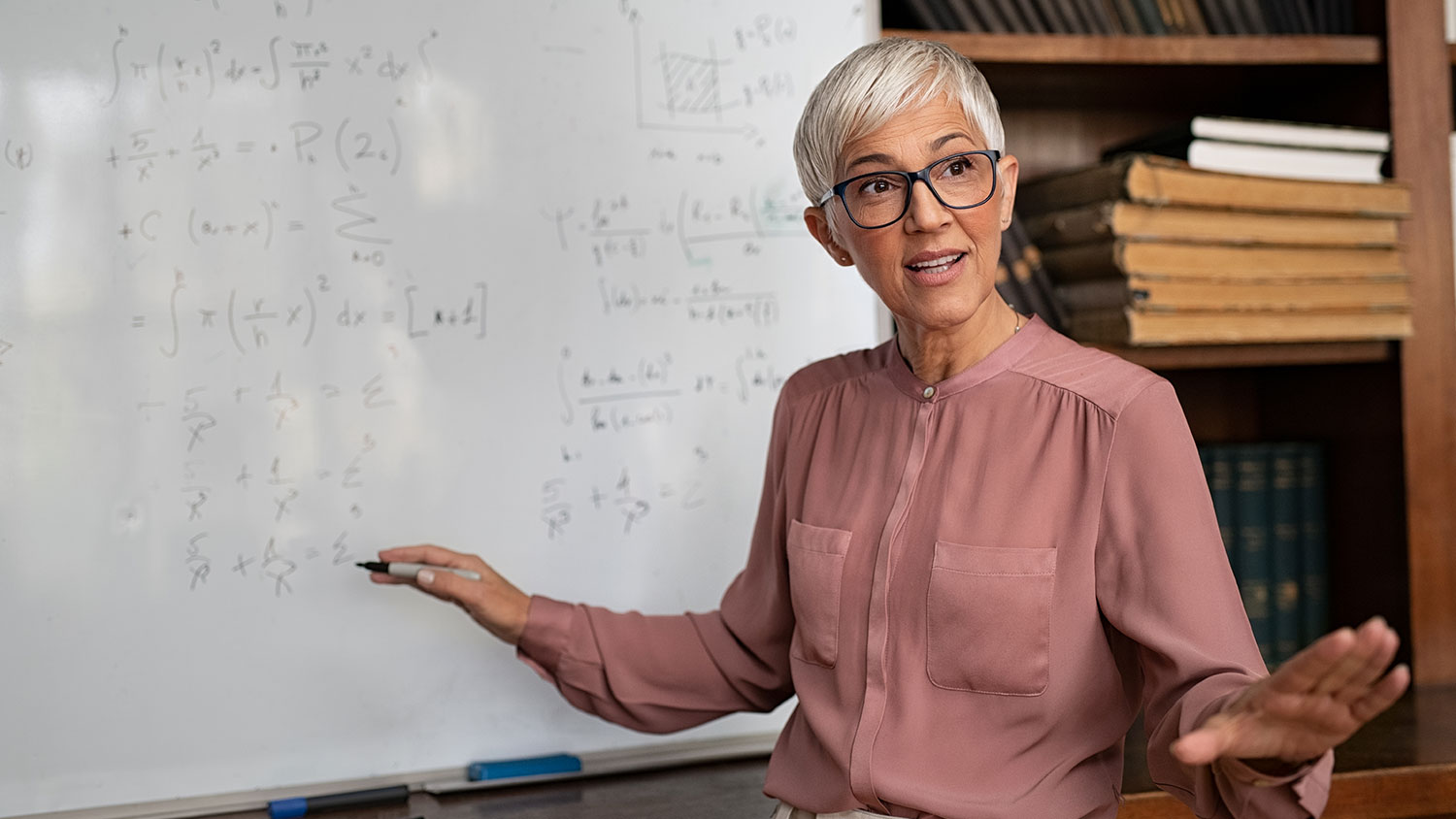 Woman professor at a whiteboard