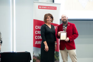 Sheri Schwab, Vice Provost for Institutional Equity and Diversity awarded Troy Hurteau the Chancellor's Creating Community Award at the annual RED Event last spring.