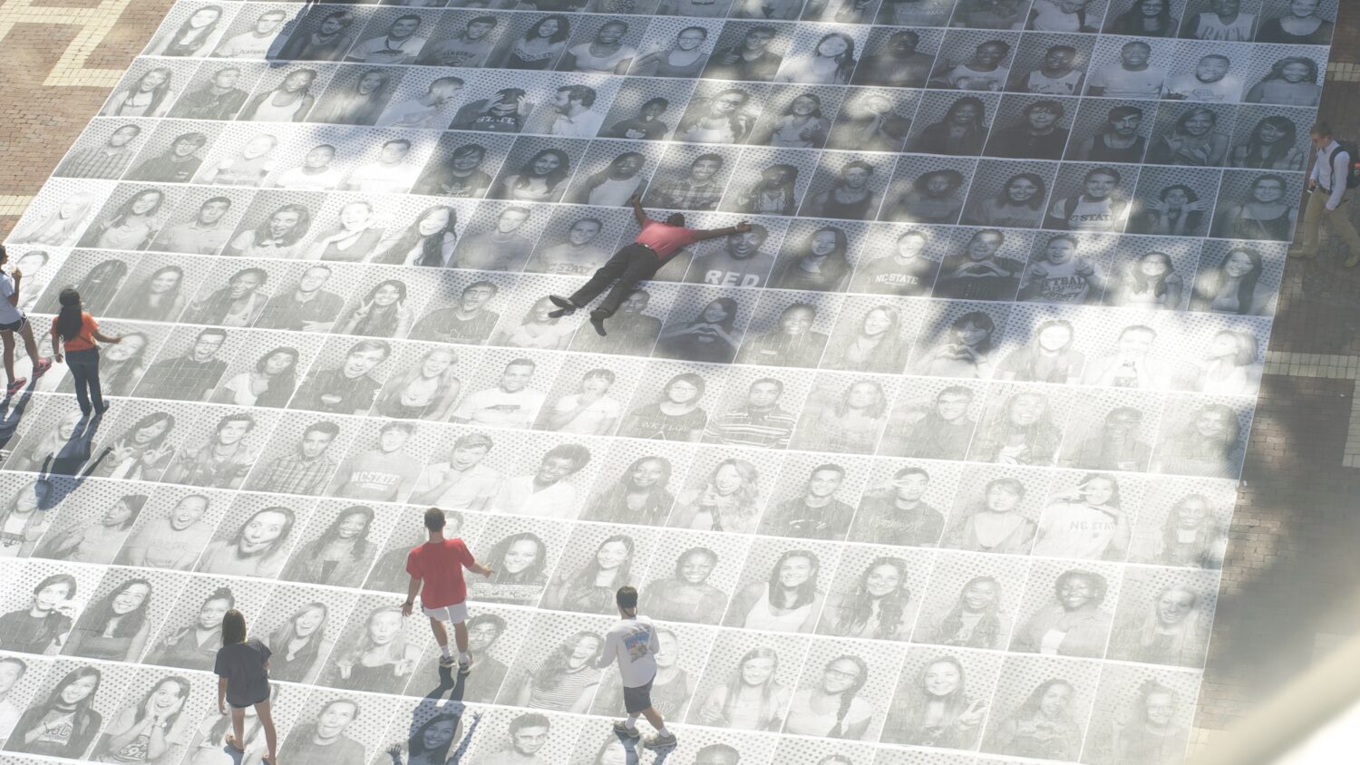 Students on image of yearbook pictures on the Brickyard