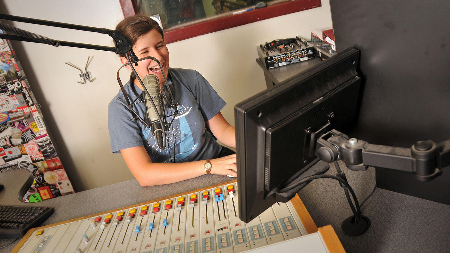 Student in front of a microphone recording.